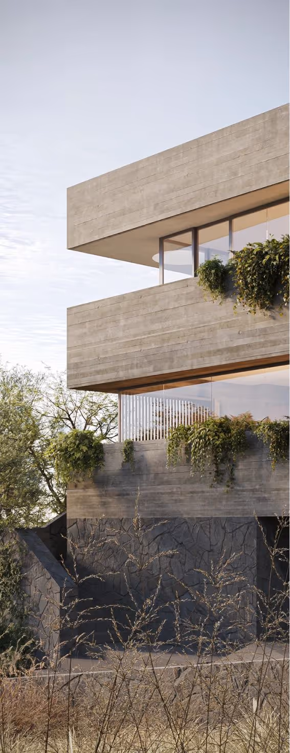 Parte de uma casa moderna com fachada cinza e janelas de vidro, decorada com plantas penduradas, cercada por vegetação seca.